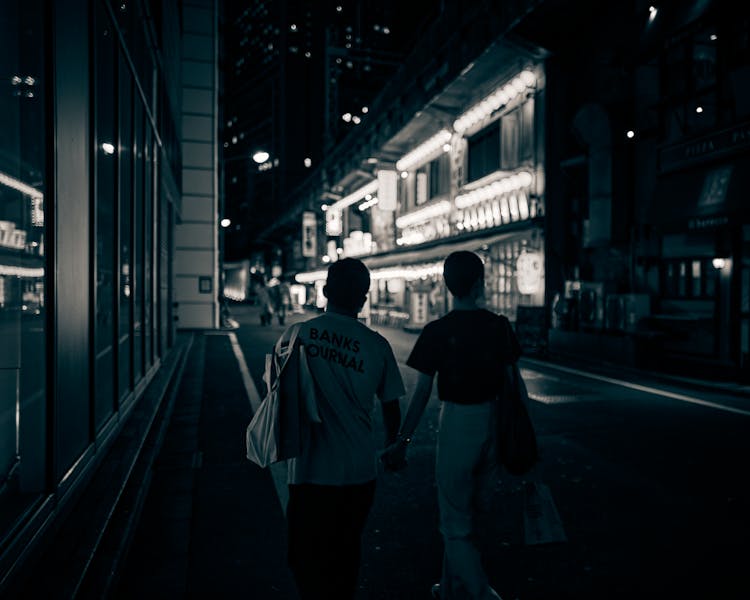 Couple Walking On Street During Night Time