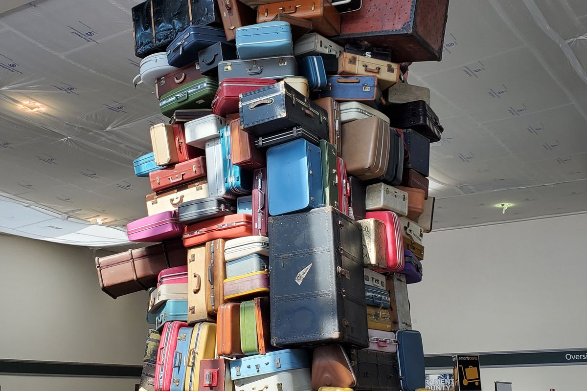 Suitcases stacked in a luggage area