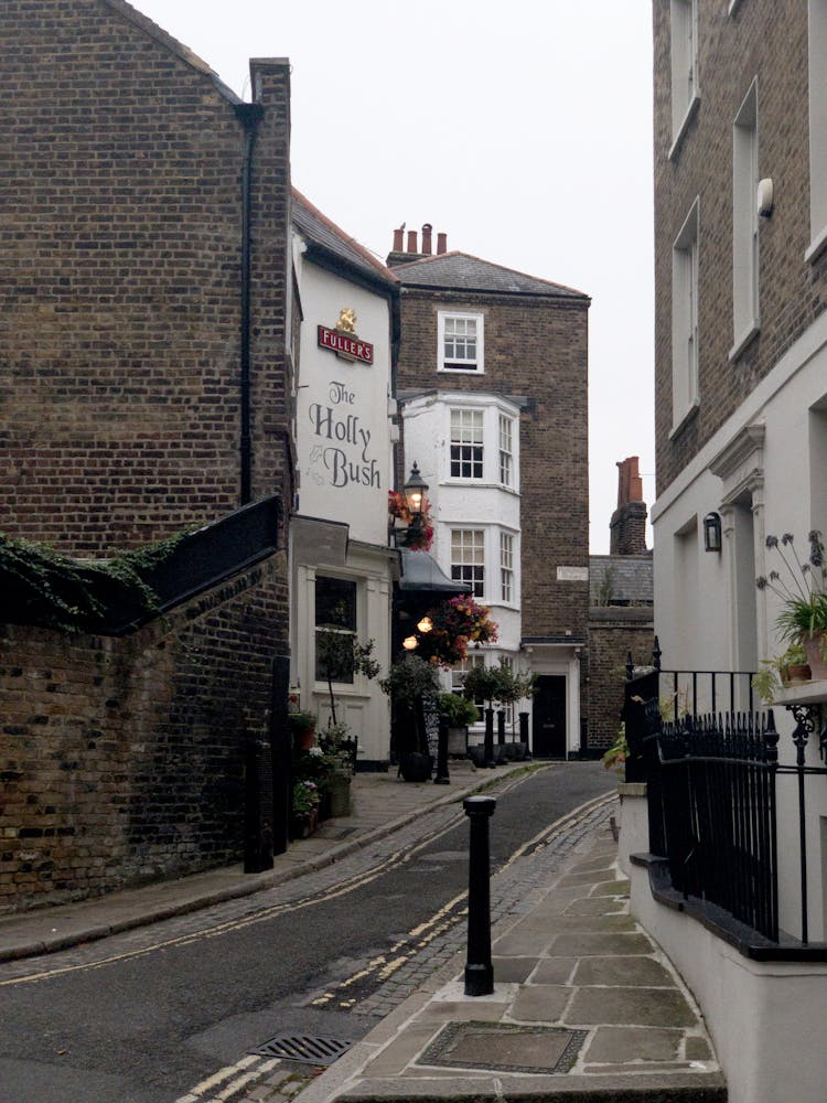 Narrow Road In Between Brown Brick Buildings 