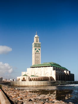 Stunning view of Hassan II Mosque against a blue sky in Casablanca, Morocco.