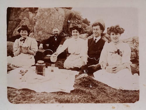 Grayscale Photo of Group of People Having a Picnic