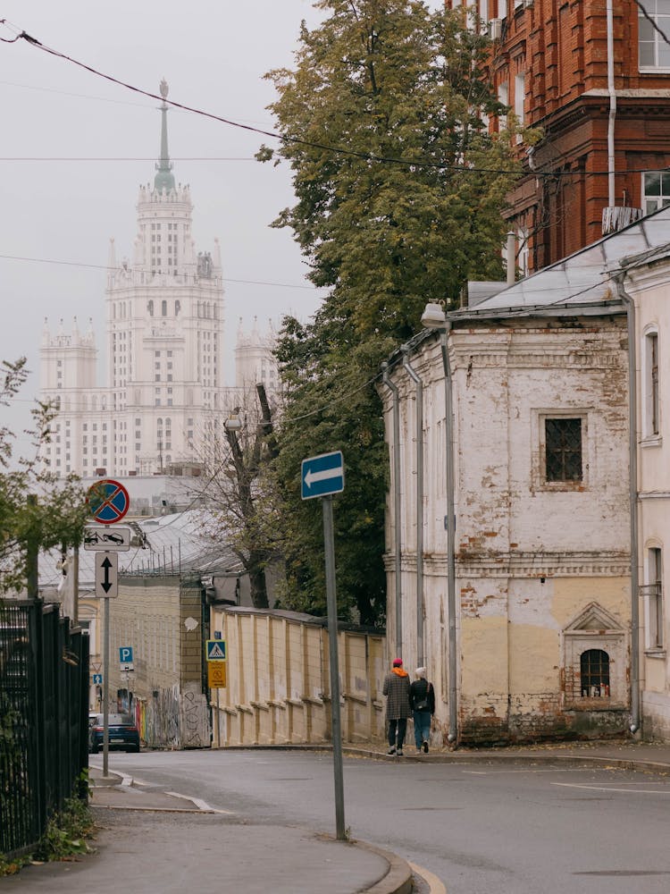 Man And Woman Walking On City Street