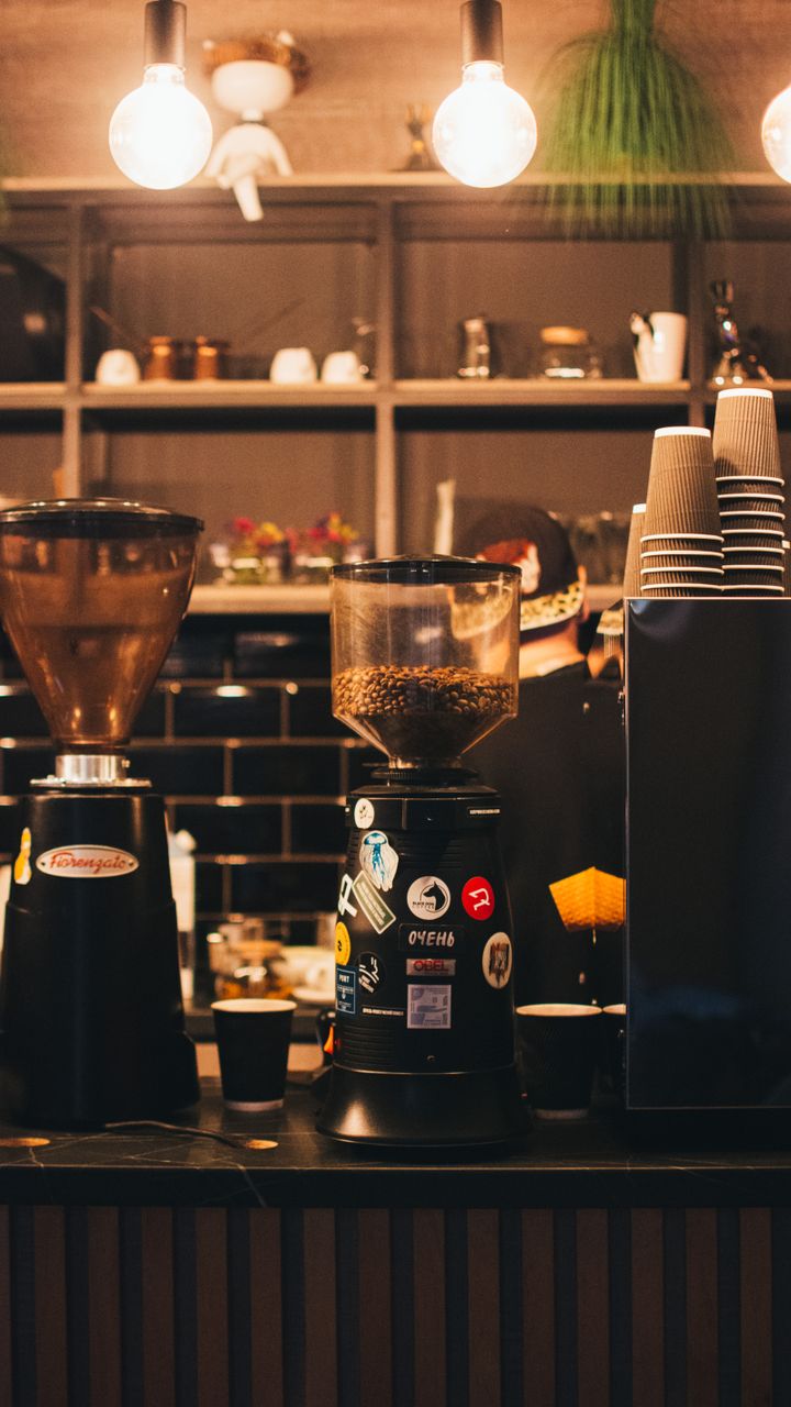 Stainless steel custom engraved coffee grinder on a modern office coffee bar counter