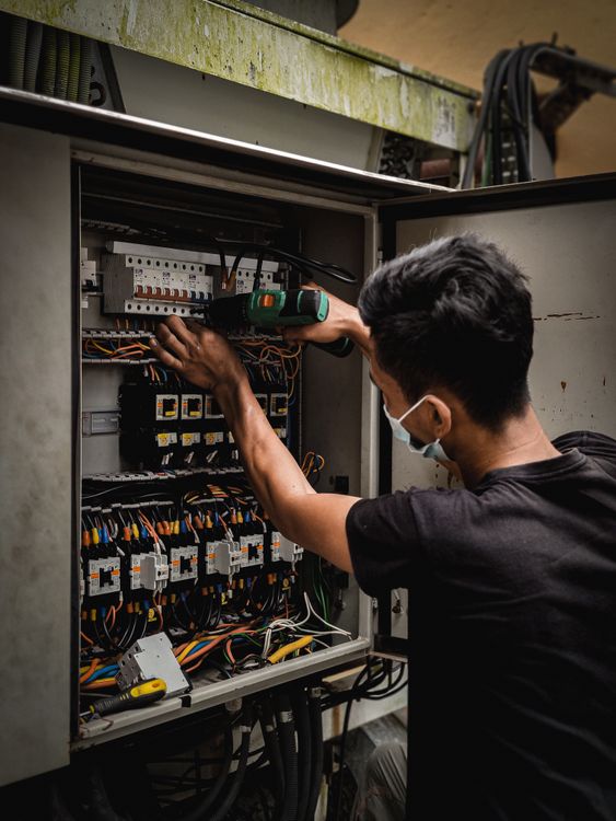 electrician performing electrical wiring work professional