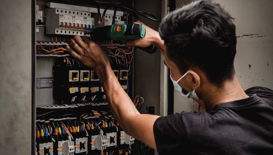 Electrician checking electrical panel