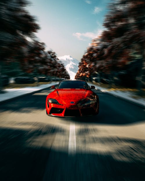 Blur Photo of a Red Toyota Supra on the Road 