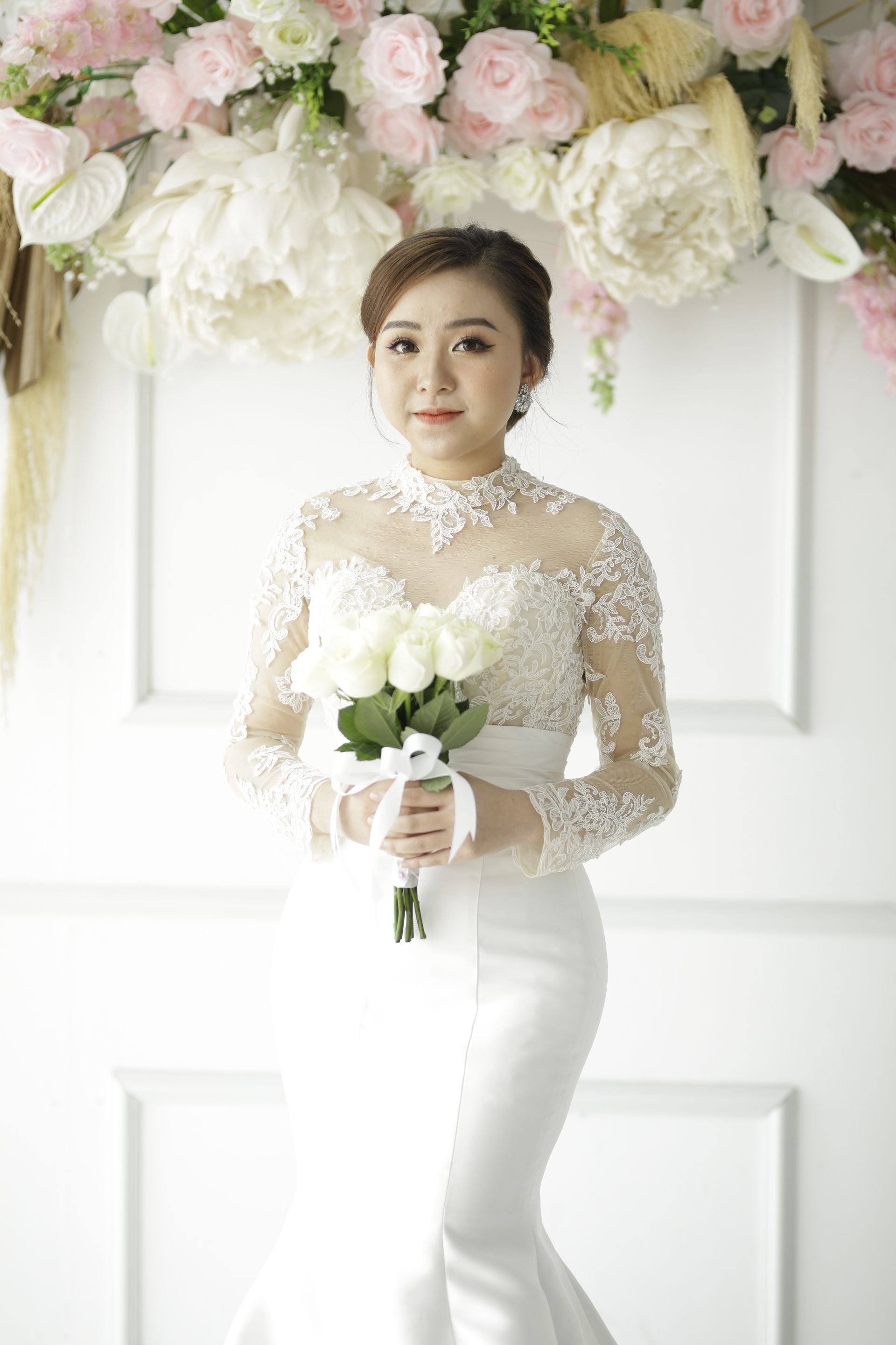 Woman in White Floral Dress Holding a Bouquet of Flowers · Free Stock Photo