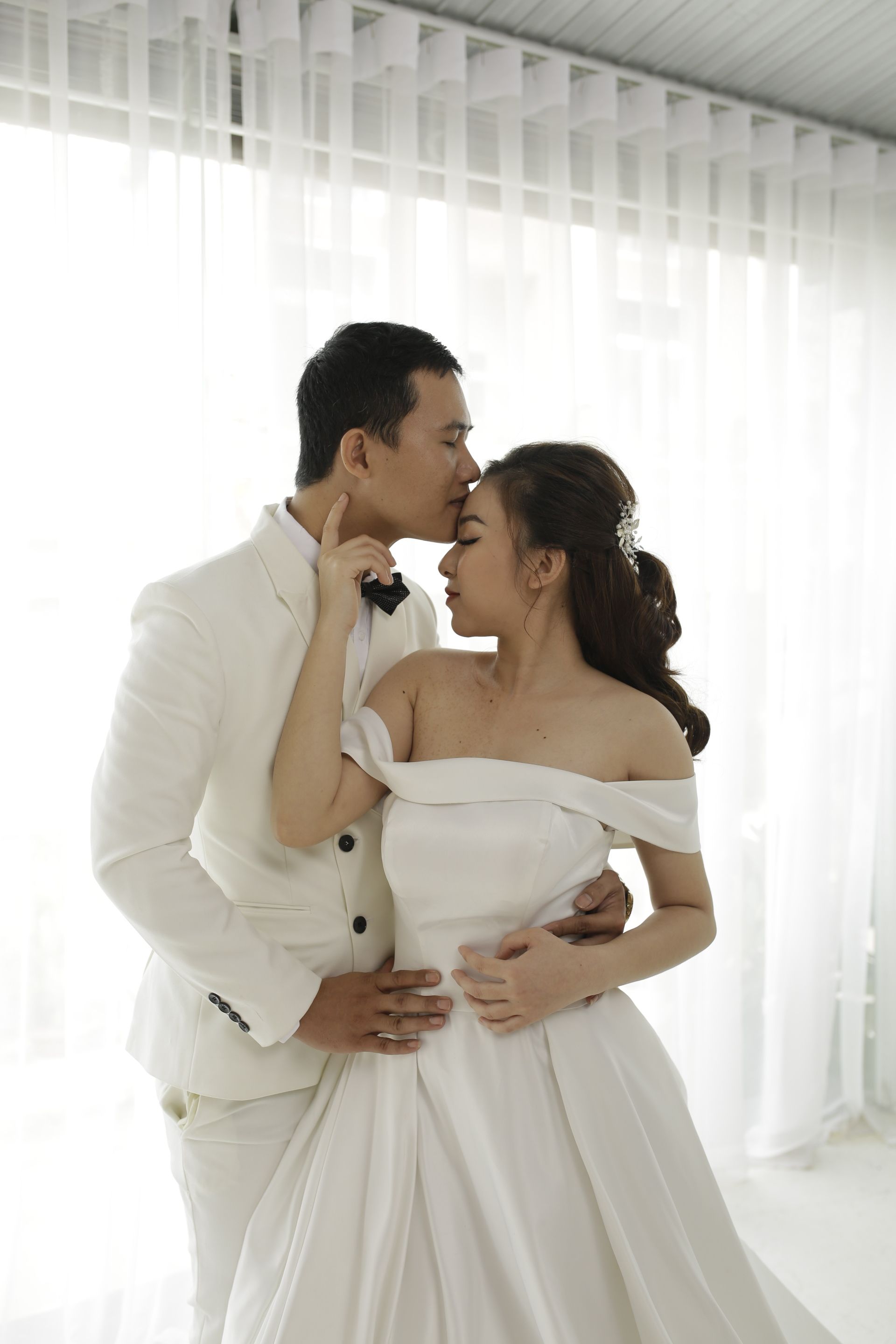 Man in White Suit Kissing a Woman · Free Stock Photo