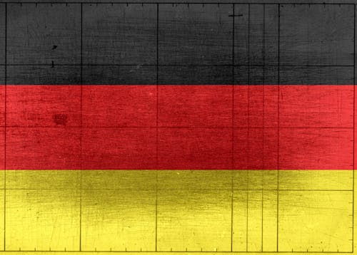 Grungy background designed as flag of Germany on shabby wooden board with measure scale