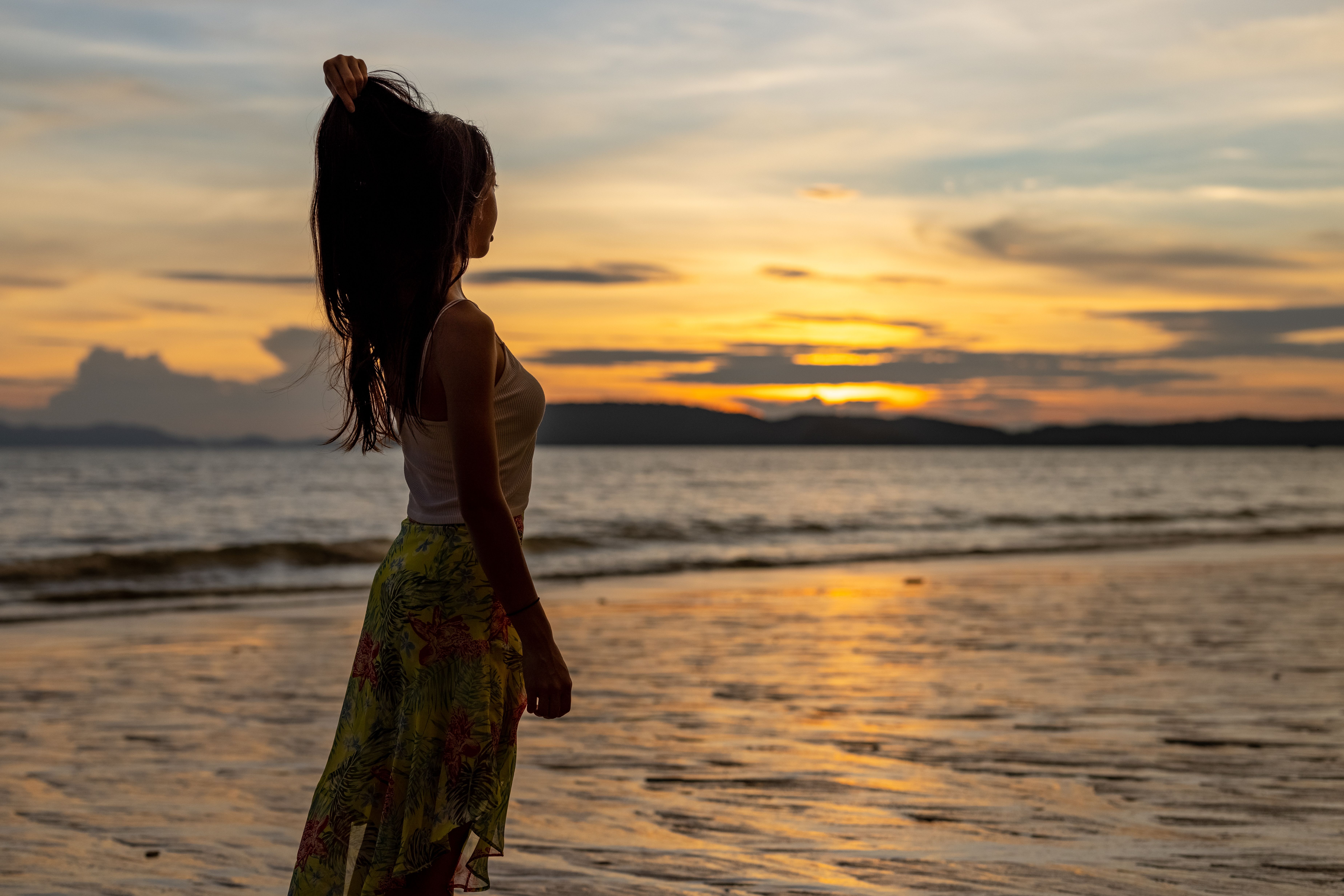 A Woman at the Beach During Sunset · Free Stock Photo