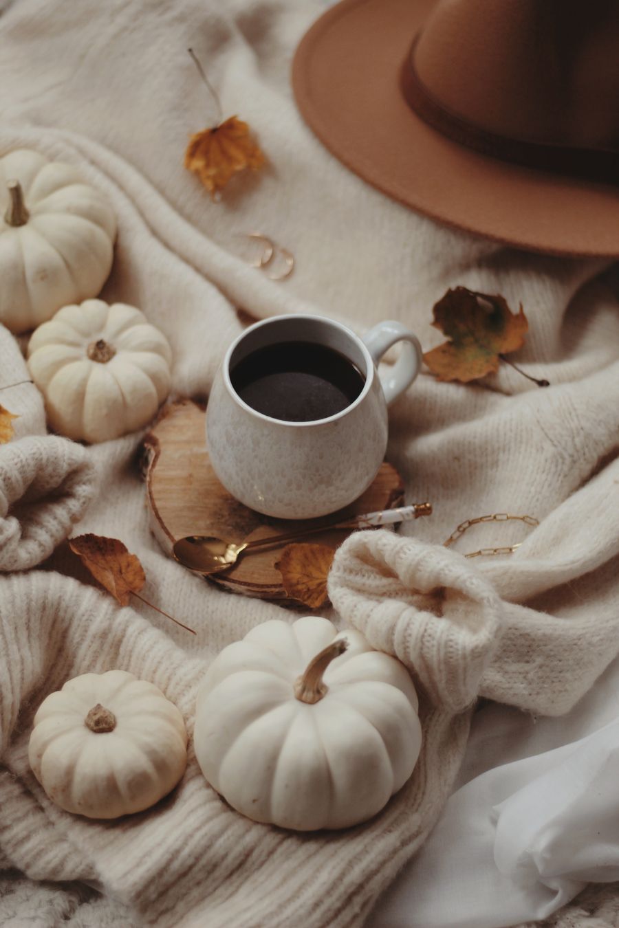 Warm fall scene with coffee pumpkins and cozy seasonal decor