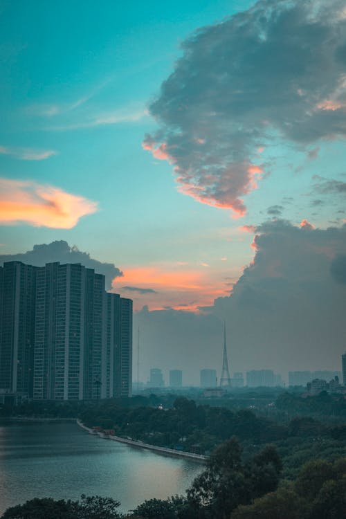 Free City Skyline Under Orange and Blue Cloudy Sky during Sunset Stock Photo