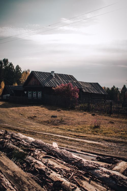 Free Charming wooden house amidst an autumn landscape, showcasing rustic beauty and tranquility. Stock Photo