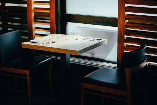 A stylish dining setup with a wooden table and chairs, perfect for a cozy meal.