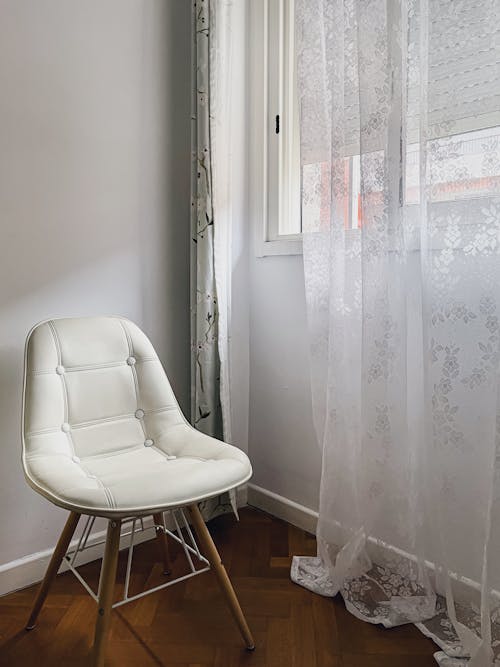 Free White Chair by a Window Stock Photo