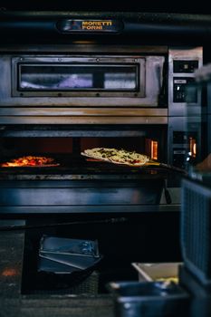 Freshly baked pizza in a commercial oven, perfect for culinary themes.