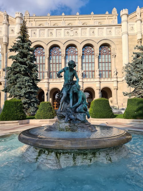 Man Riding Horse Statue in Front of White Building