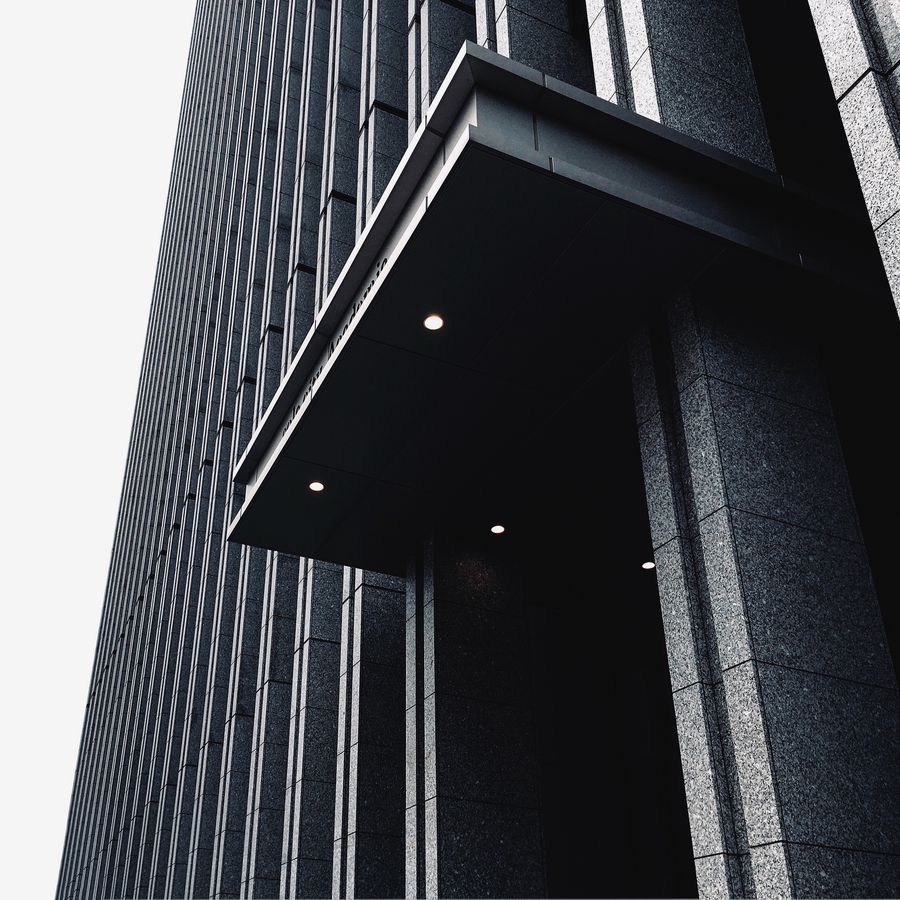 Release card artwork: a dark facade canopy — photo by Bryan Koh on Pexels