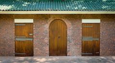 Brown Wooden Door on Brown Brick Wall
