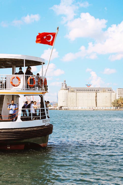 People Riding on White and Black Boat on Sea