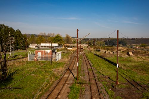 Free Aerial view of railroad tracks through picturesque countryside under a clear sky. Stock Photo