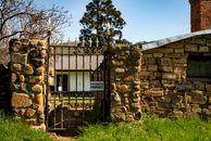 Brown Block Wall With Black Metal Gate