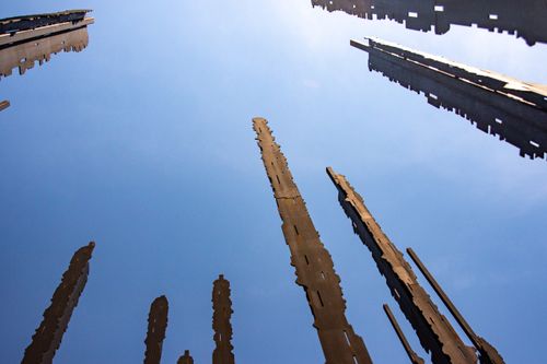 Free Low angle view of towering abstract structures against a clear blue sky. Stock Photo