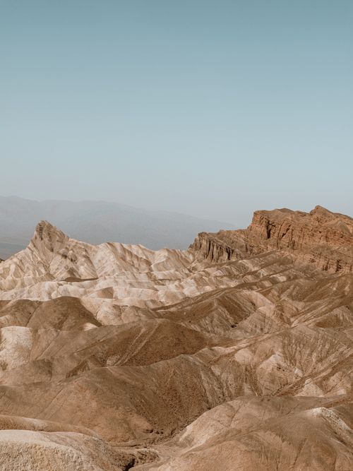 Free Explore the majestic eroded hills in serene barren landscapes with clear blue sky. Stock Photo