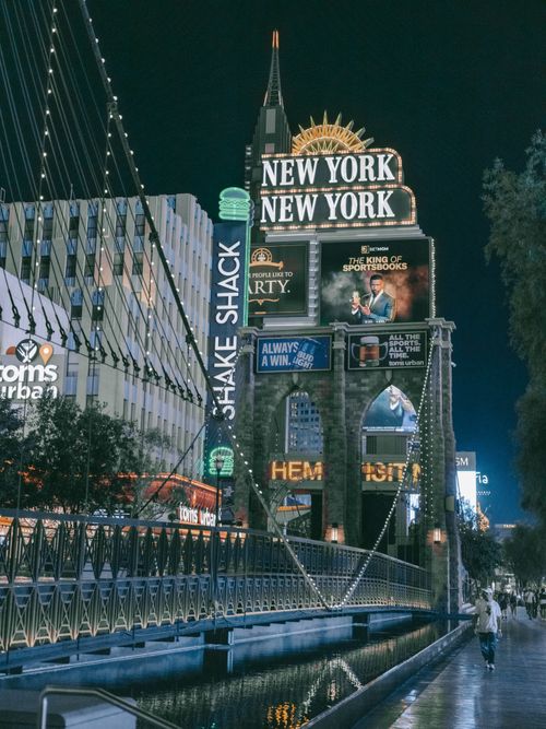 Free Scenic night view of New York-New York Hotel in Las Vegas with bright signs and city ambiance. Stock Photo