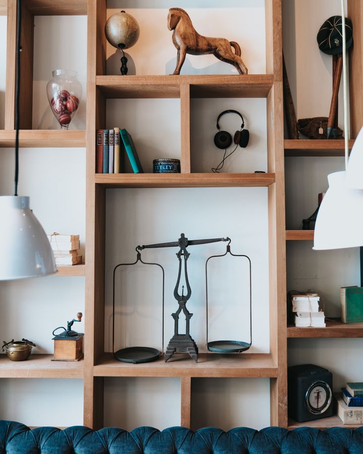 Wood storage shelves with books and framed decorative objects