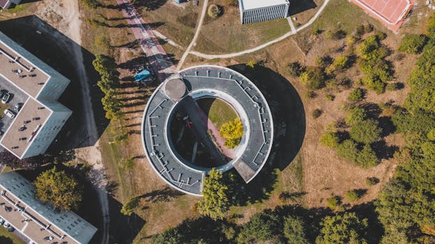 Drone shot of a circular building amidst greenery in Bordeaux, France.