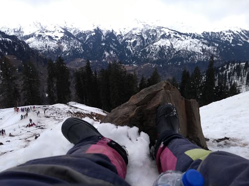 Person Wearing Black Boots At Snowy Mountain