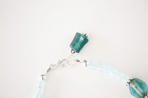 Free Close-up of a gemstone necklace with metal clasp on a white background. Stock Photo