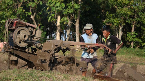 2 Men Operating the Hand Tractor
