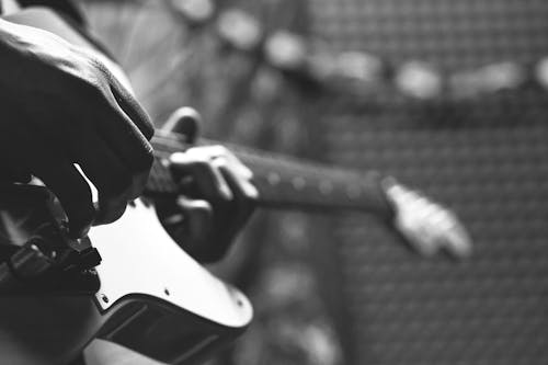 Free Grayscale Photo of Person Holding Electric Guitar Stock Photo