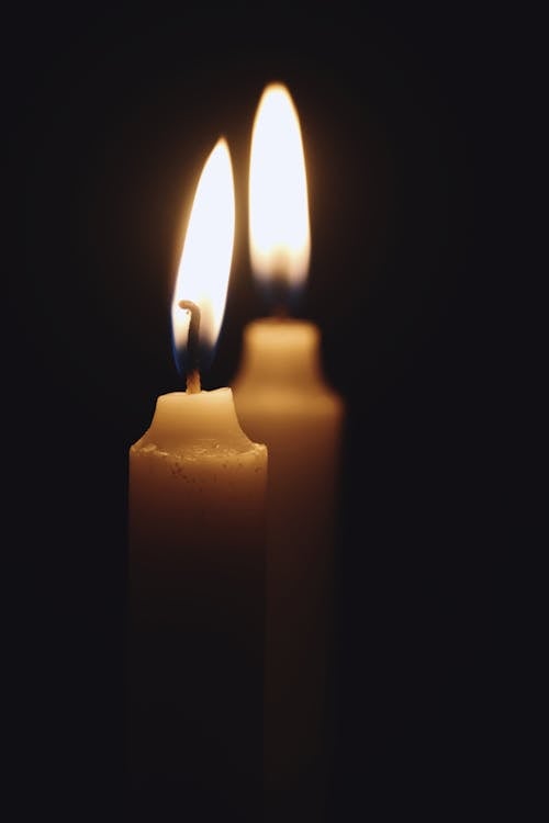 White Candles on Black Background