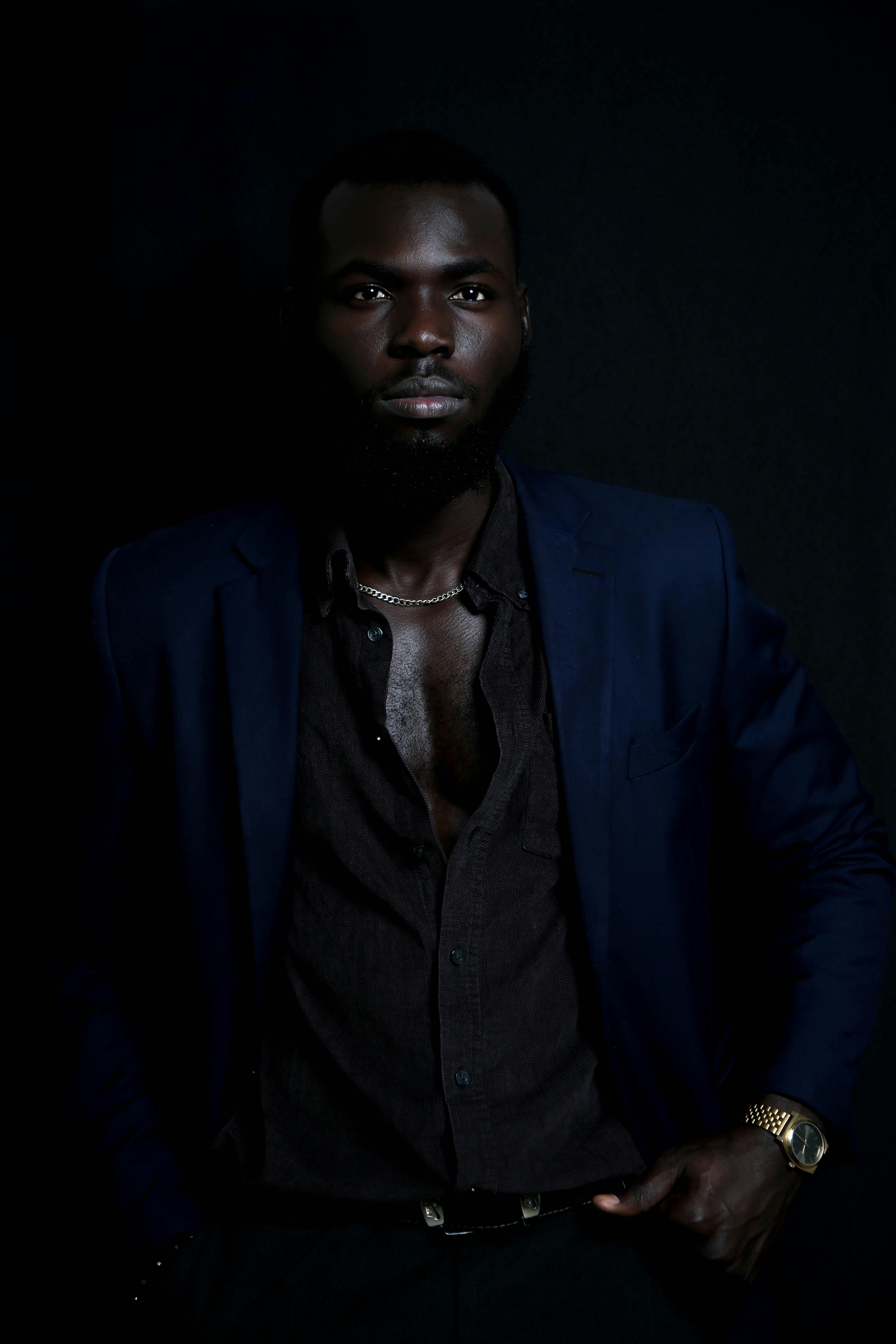 Close-Up Photo of a Handsome Man in a Black Suit Looking at the Camera ·  Free Stock Photo