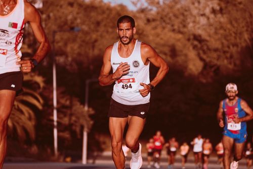 Free Marathon runners competing outdoors, showcasing determination and athleticism. Ideal for fitness and sports themes. Stock Photo