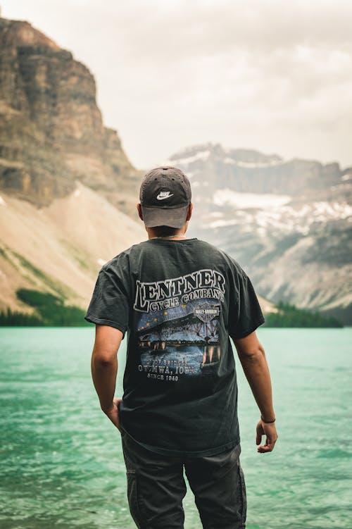 A Man in Black Shirt Standing Beside the lake