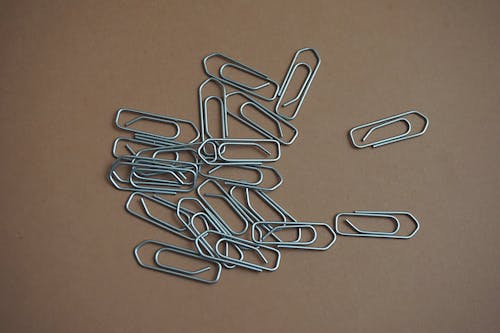 Gray Paper Clip on Brown Table