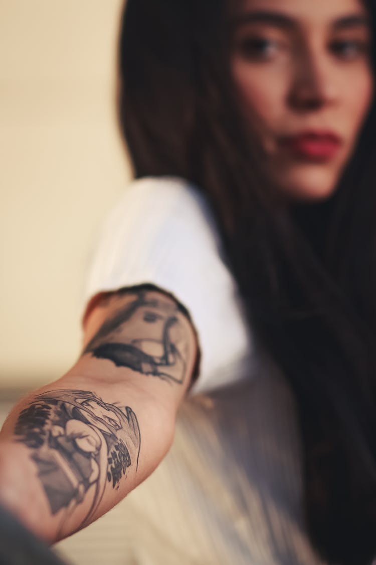 Woman With Tattoos On Her Arm