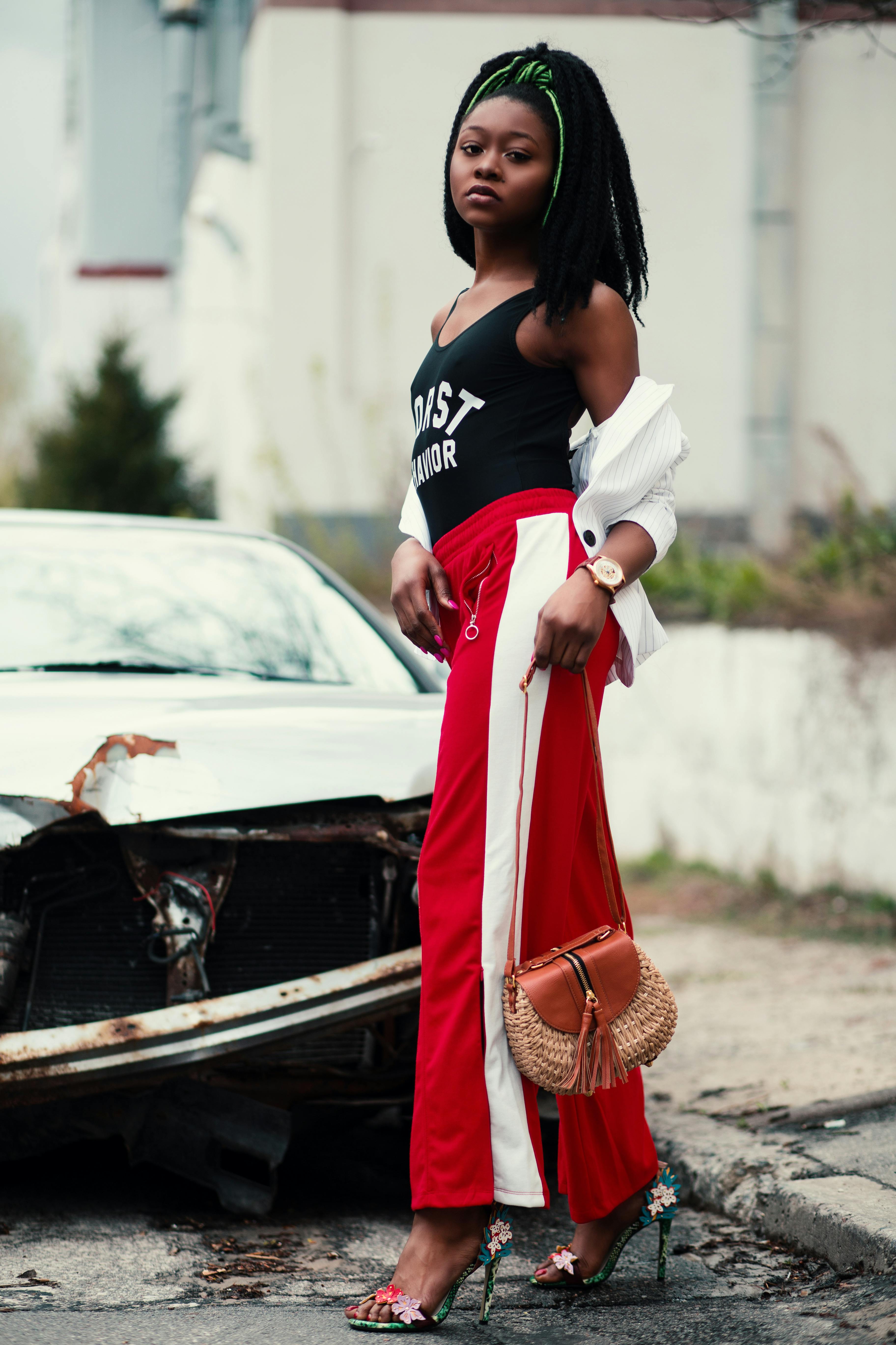 Women's Black Tank Top Red Track Pants Walking on Street · Free Stock Photo
