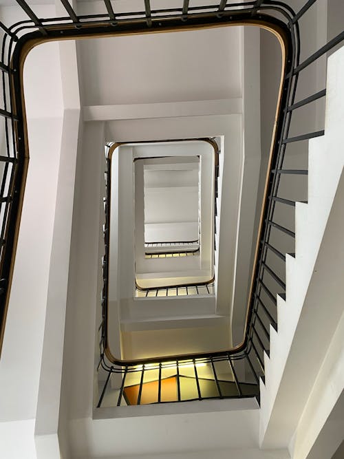 White Staircase With Black Metal Railings