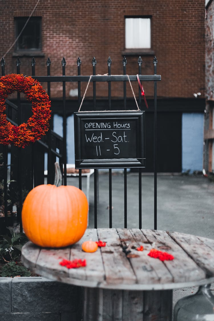 Store Chalkboard Sign Over A Table With A Pumpkin