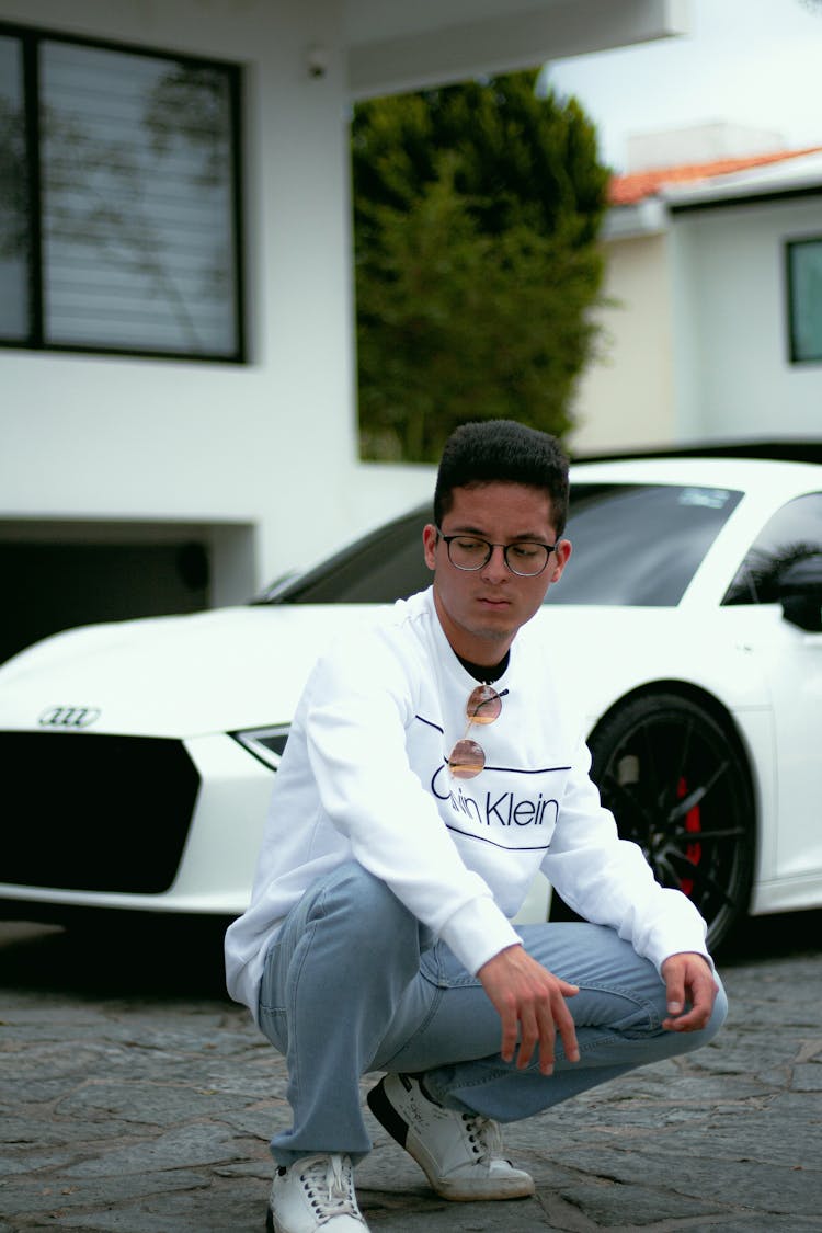 Man In White Sweater Posing Near The White Car