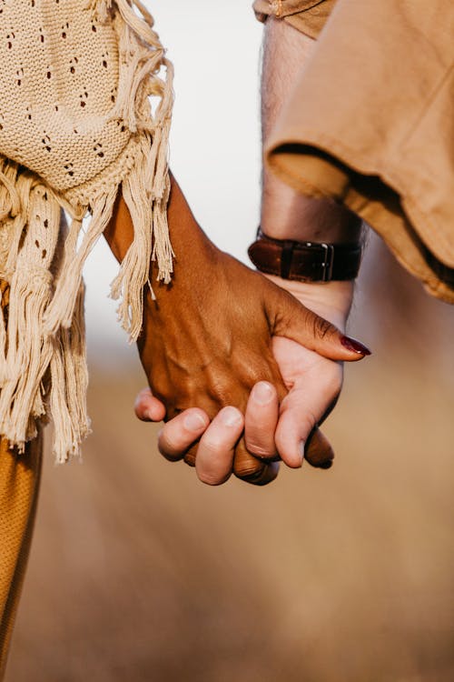 Close view on black womans hand with white mans hand