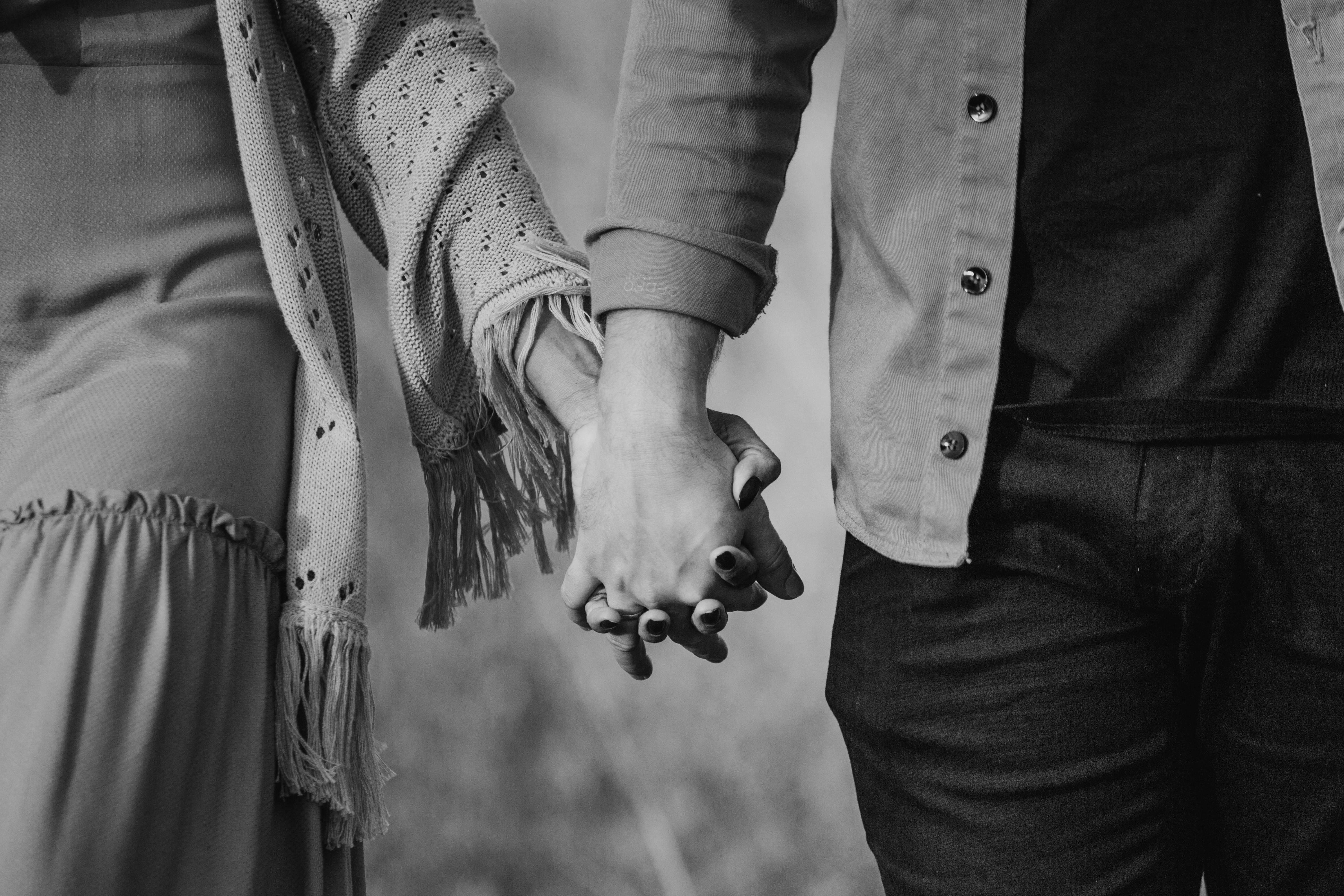 Couple holding hands grayscale romantic