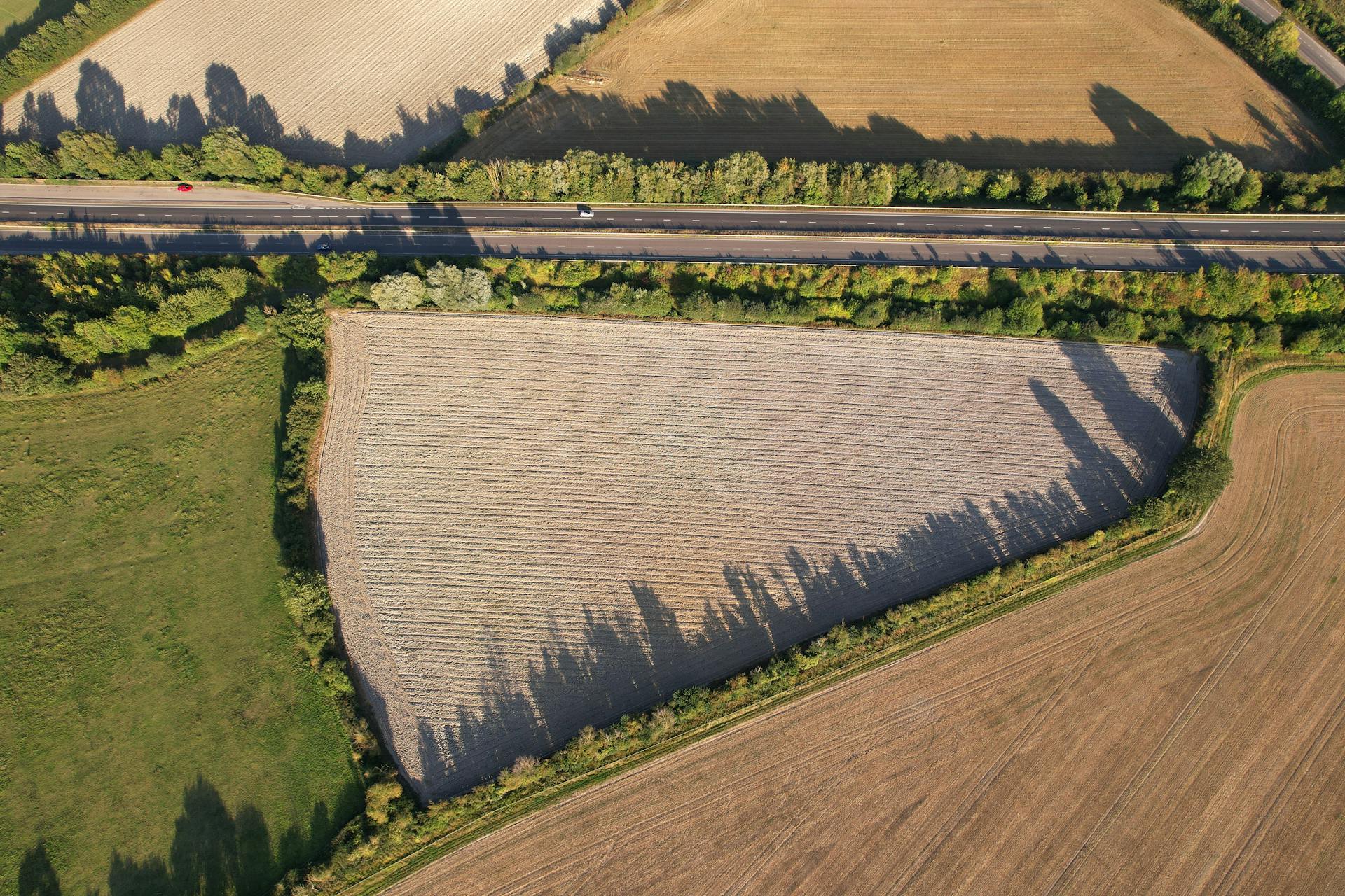 Aerial view of farmland and road in Central Bedfordshire, England, showcasing rural landscape.