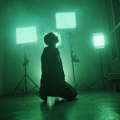 Figure lit by studio panels in haze, photo by Bobby Nguyen on Pexels