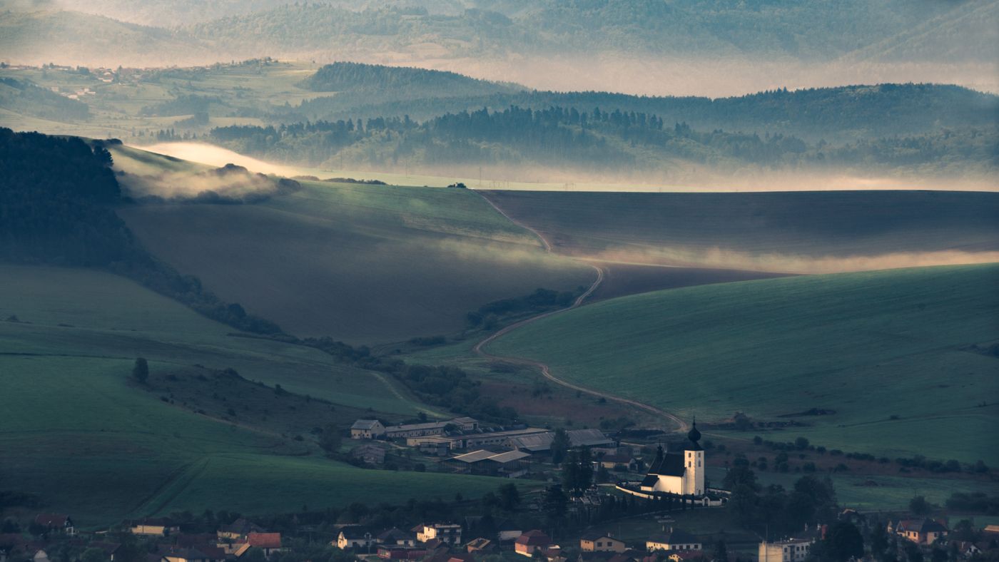 Mist rolling over green hills near the resort